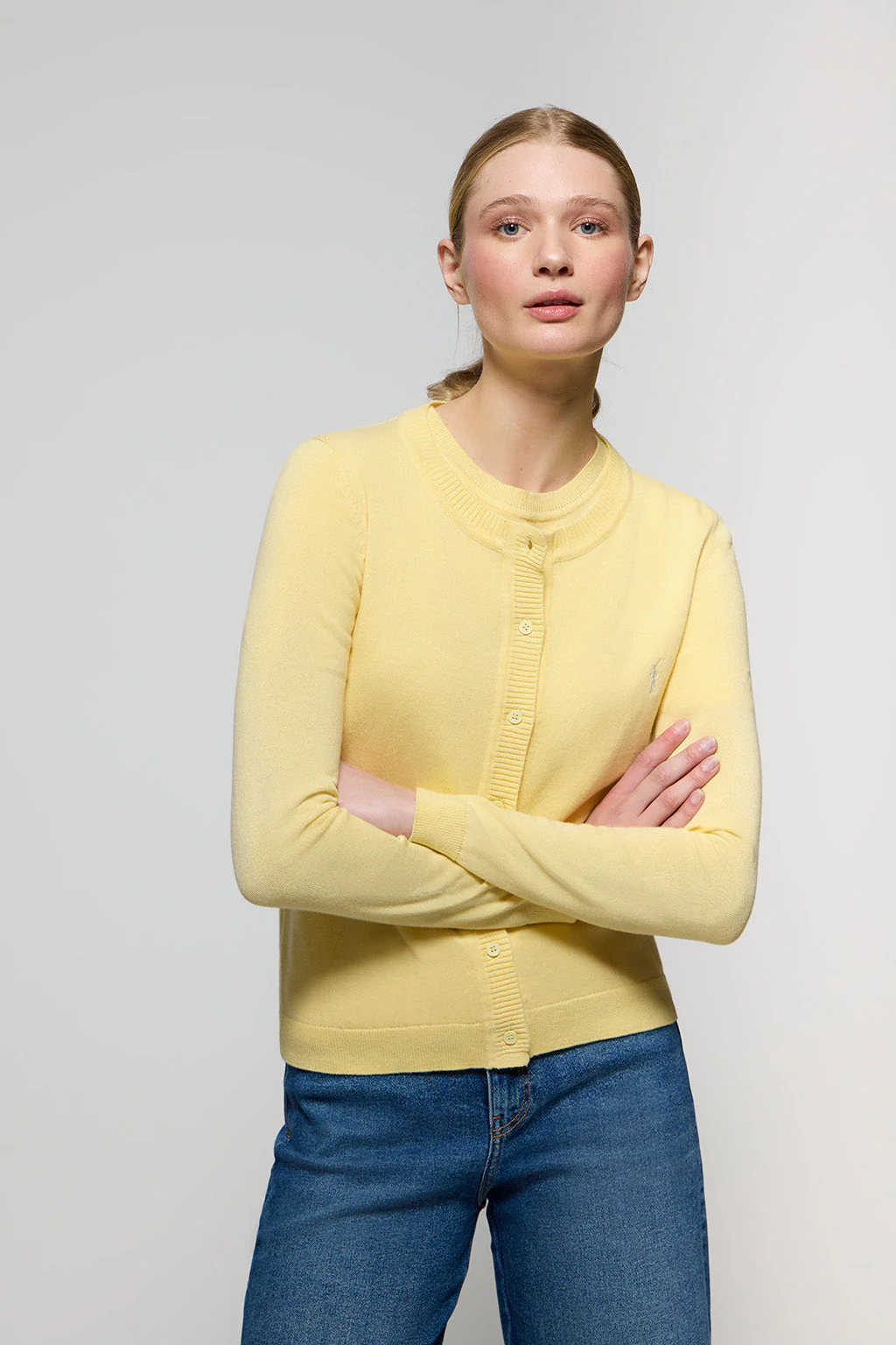 Light-yellow knit cardigan with buttons and embroidered Rigby Go logo