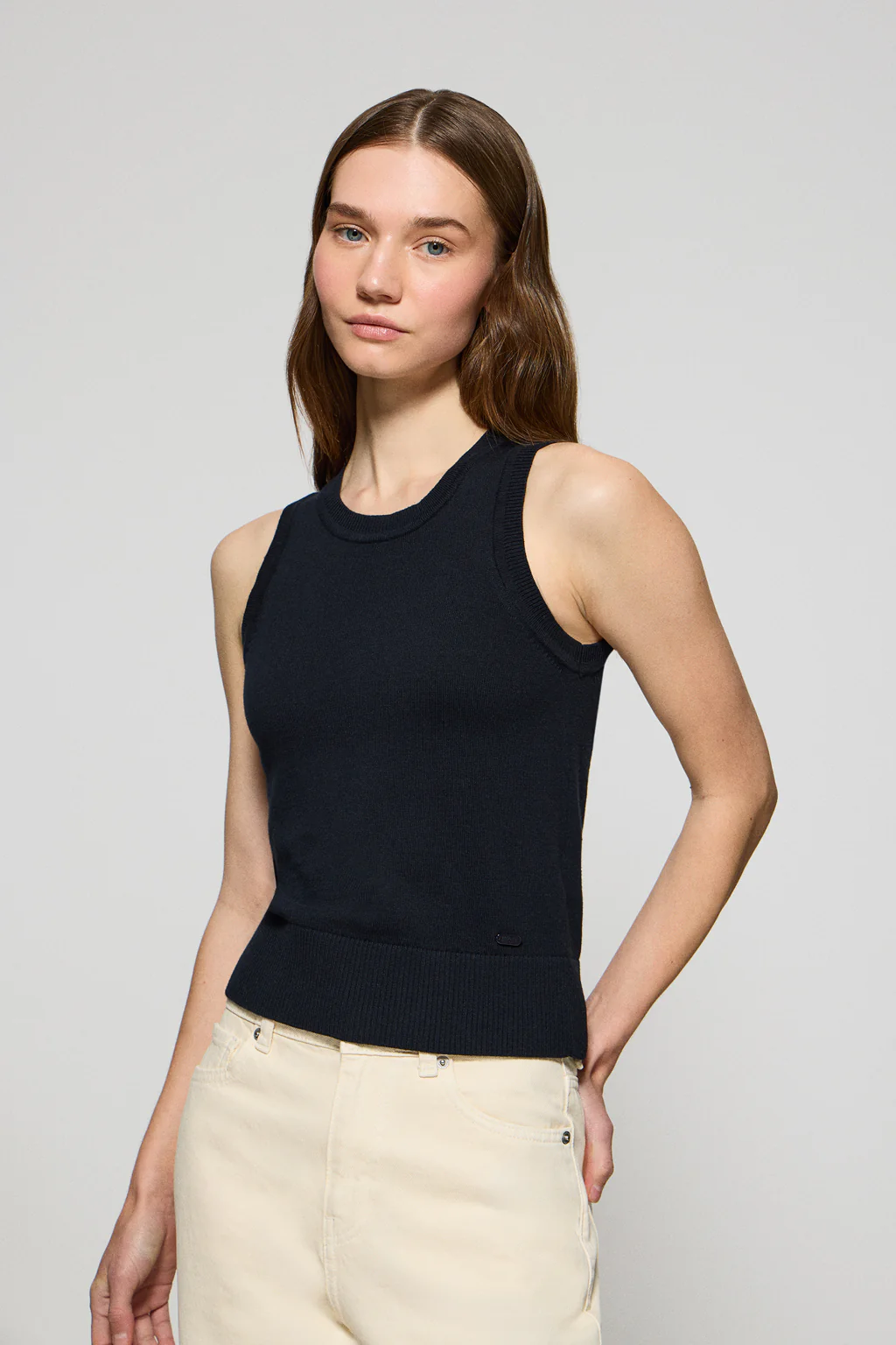 Navy-blue sleeveless jumper with pearly button