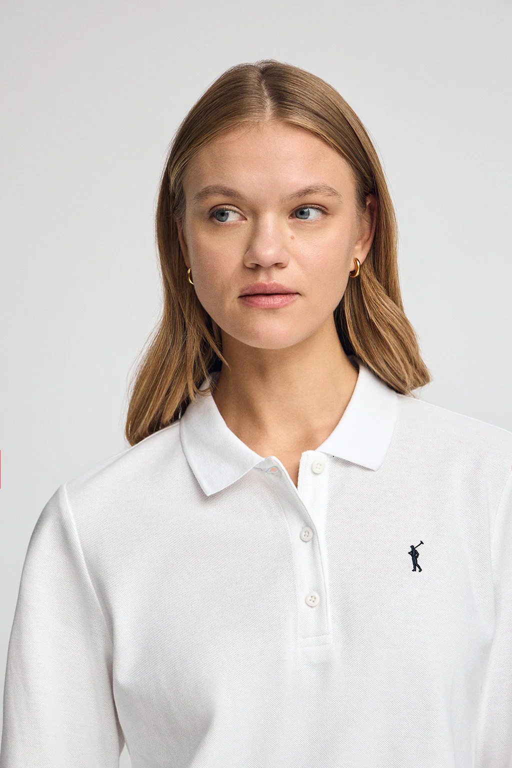 White long-sleeve polo shirt with three-button collar and Rigby Go embroidery