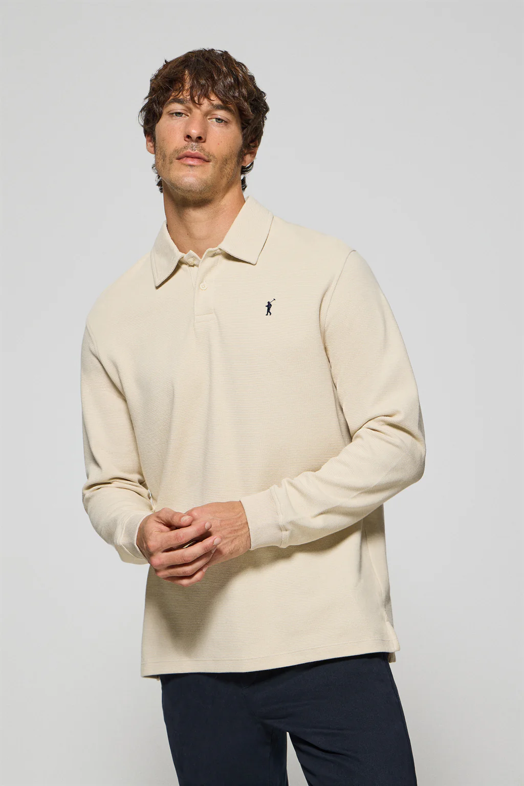 Beige long-sleeve polo shirt with two buttons and Rigby Go logo