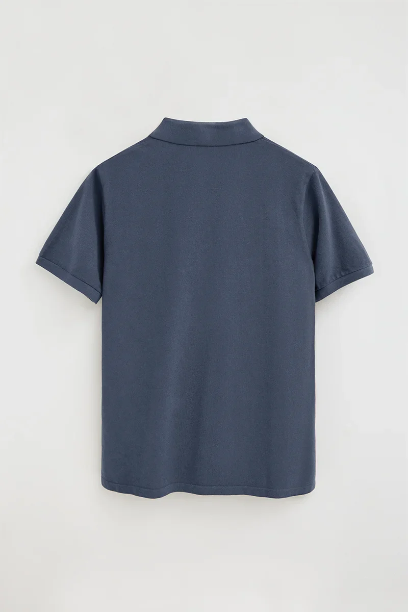 Denim-blue garment-dyed polo shirt with Rigby Go embroidered logo - Image 3