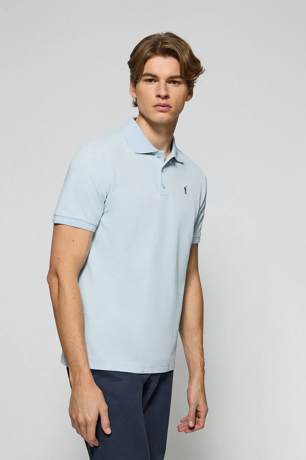 Light-blue polo shirt with three buttons and Rigby Go embroidered logo - Image 2