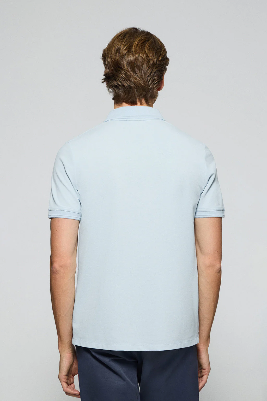 Light-blue polo shirt with three buttons and Rigby Go embroidered logo - Image 4