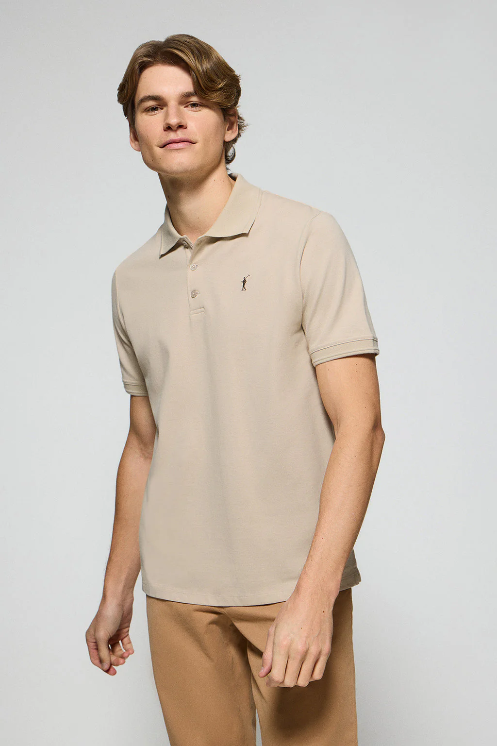 Beige polo shirt with three buttons and Rigby Go embroidered logo