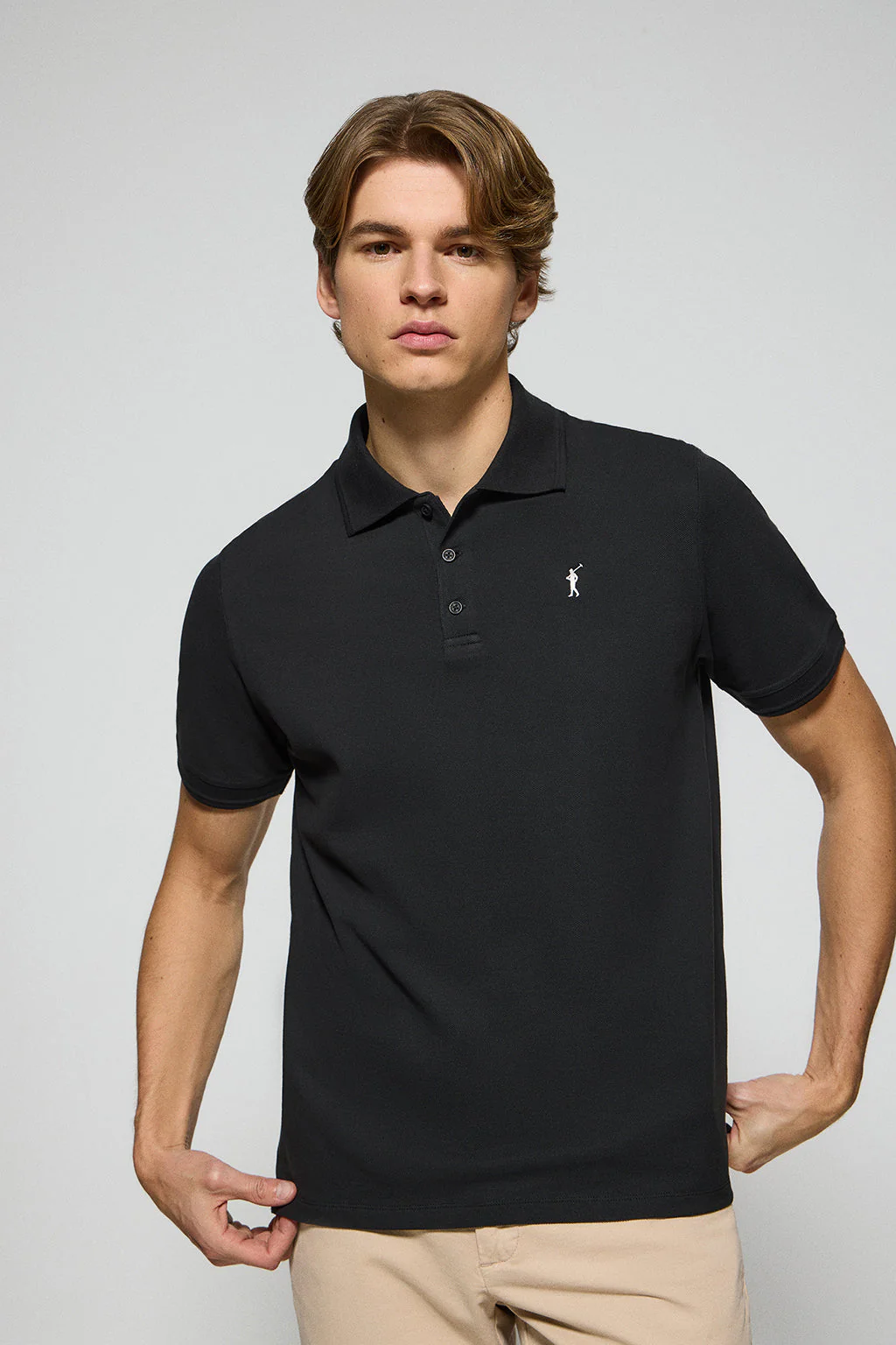 Black polo shirt with three buttons and Rigby Go embroidered logo
