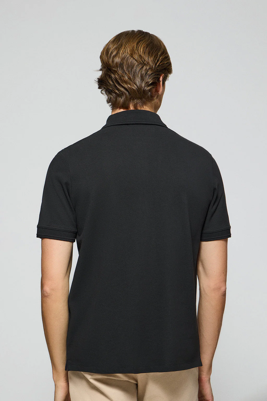 Black polo shirt with three buttons and Rigby Go embroidered logo - Image 4