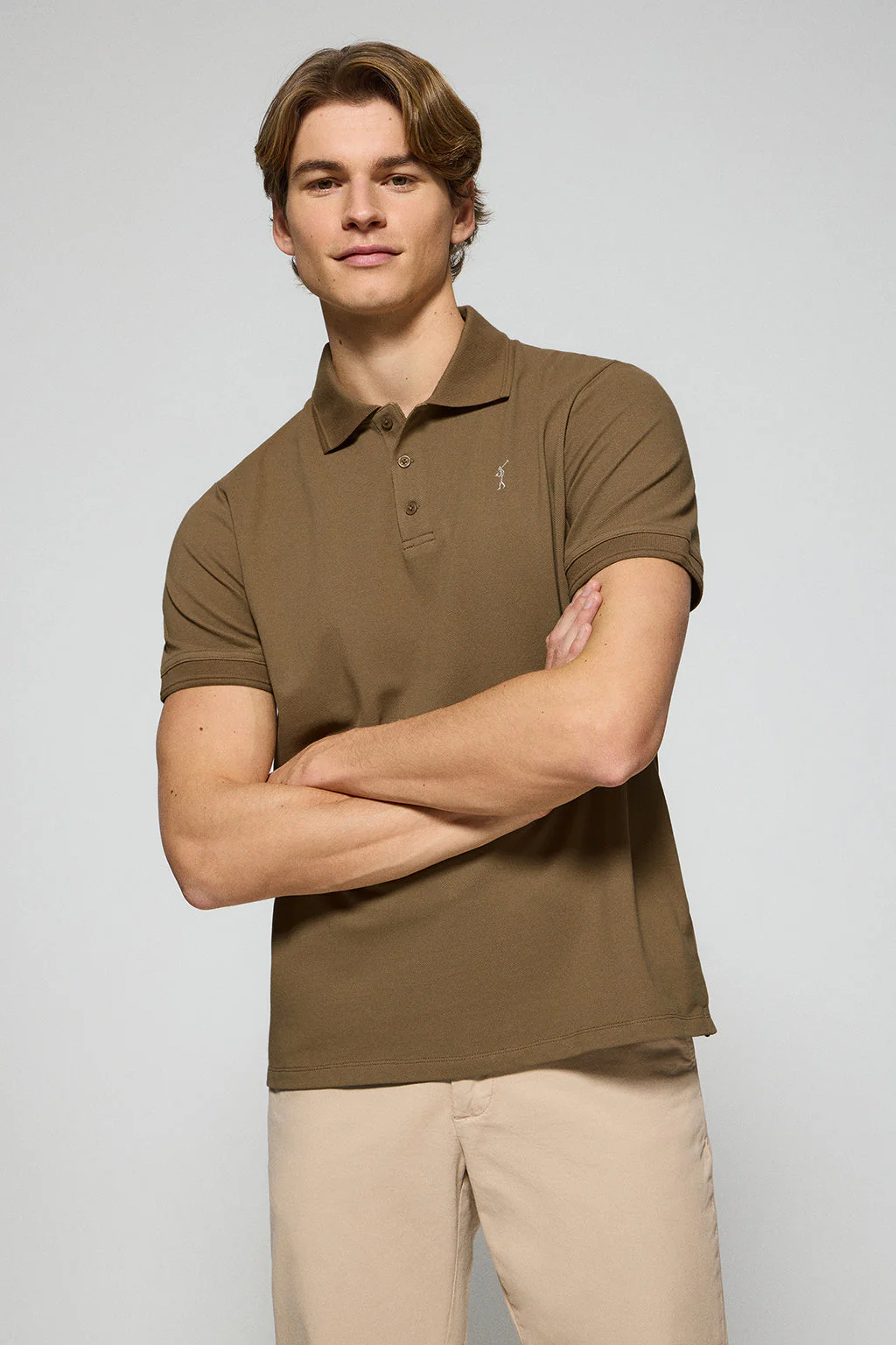 Brown polo shirt with three buttons and Rigby Go embroidered logo