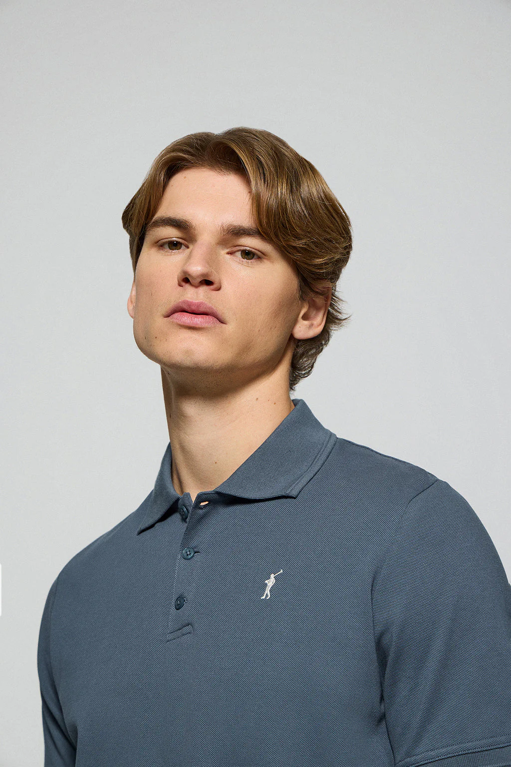 Denim-blue polo shirt with three buttons and Rigby Go embroidered logo - Image 2