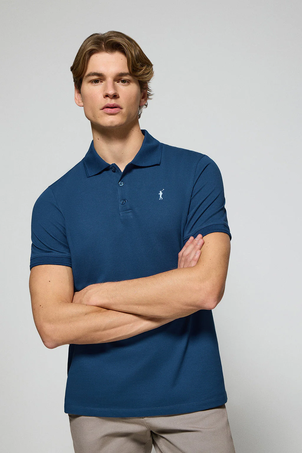 Indigo-blue polo shirt with three buttons and Rigby Go embroidered logo