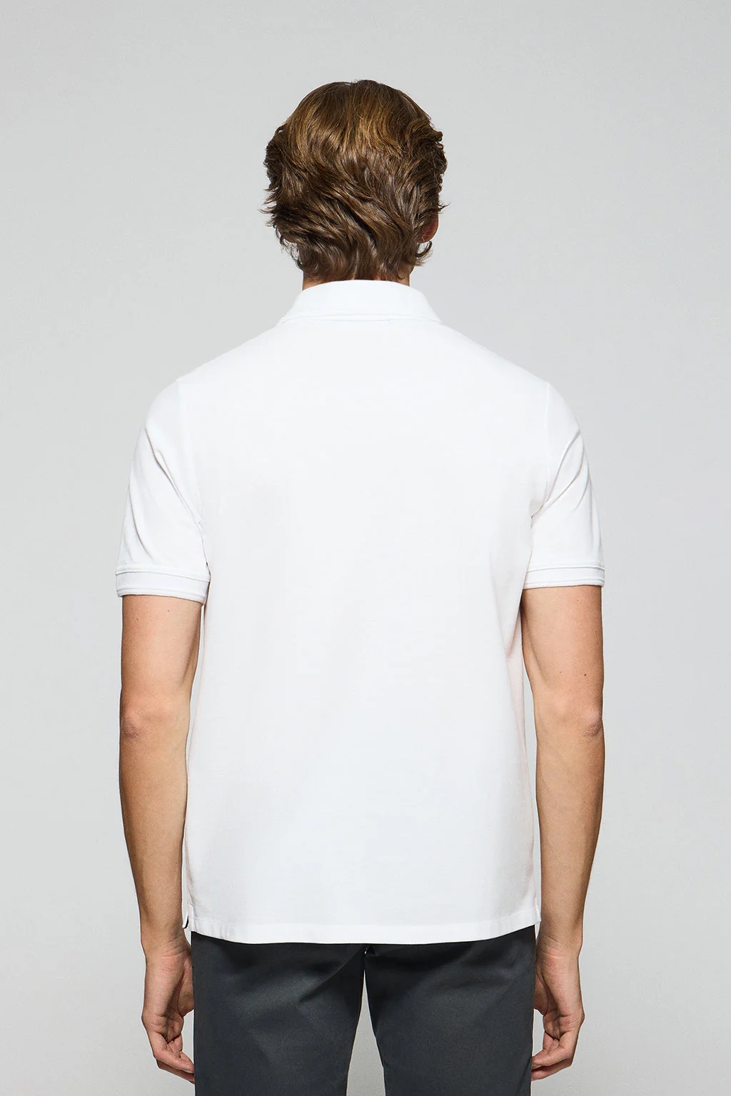 White polo shirt with three buttons and Rigby Go embroidered logo - Image 5