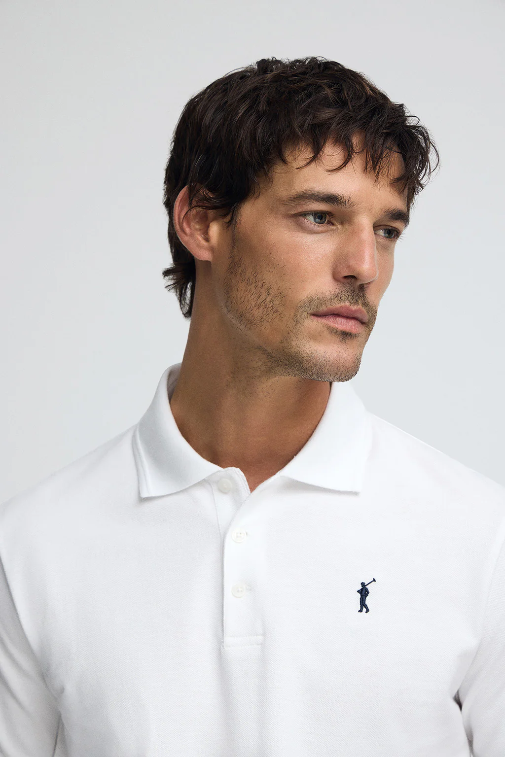White pique polo shirt with Rigby Go embroidered logo - Image 2