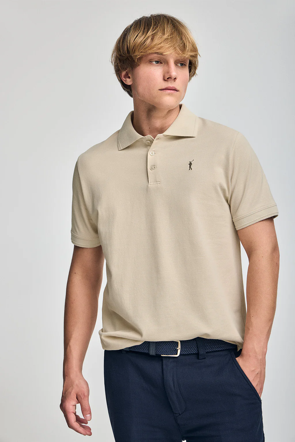 Beige short-sleeve polo shirt with three buttons and Rigby Go embroidered logo