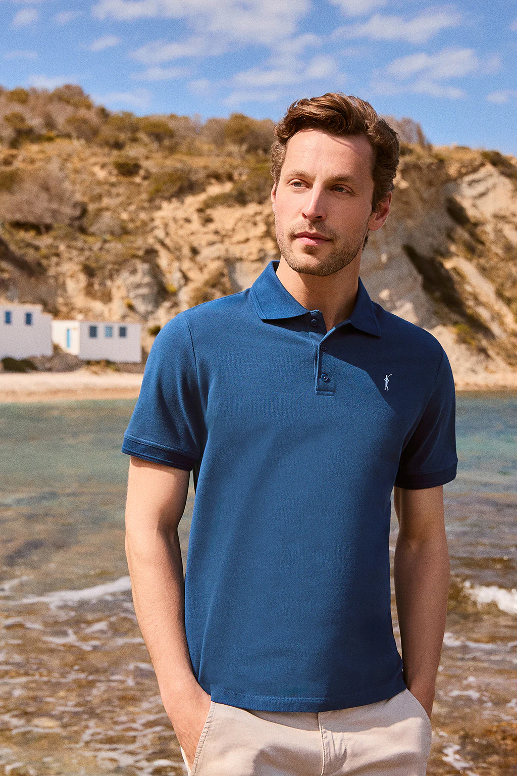 Indigo-blue short-sleeve polo shirt with three buttons and Rigby Go embroidered logo