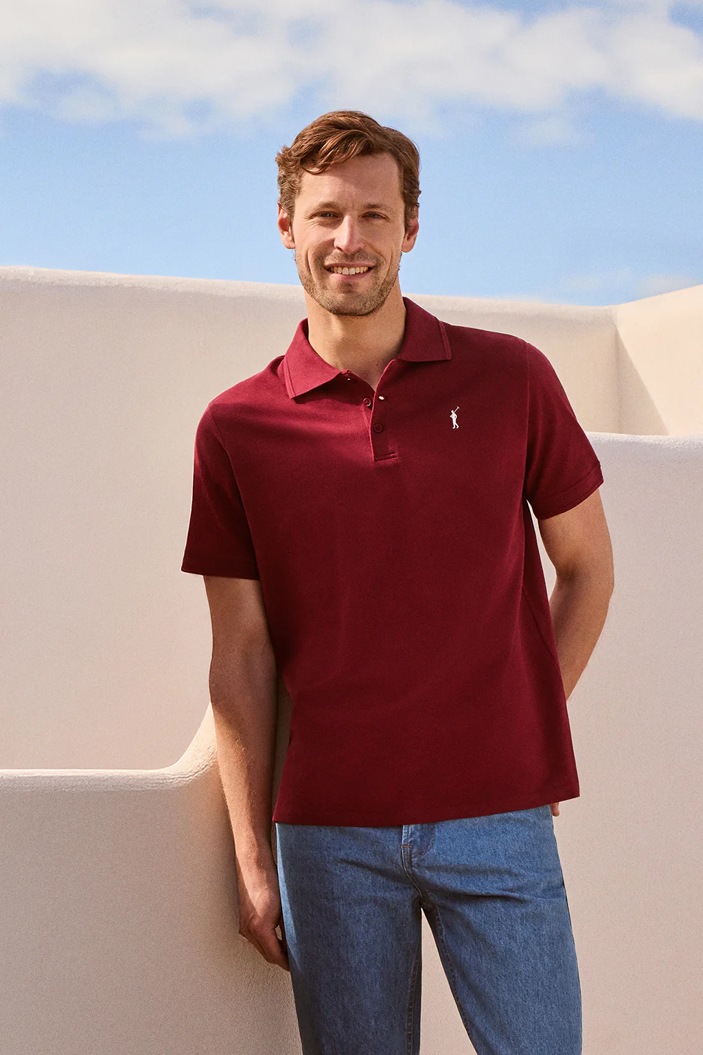Maroon short-sleeve polo shirt with three buttons and Rigby Go embroidered logo