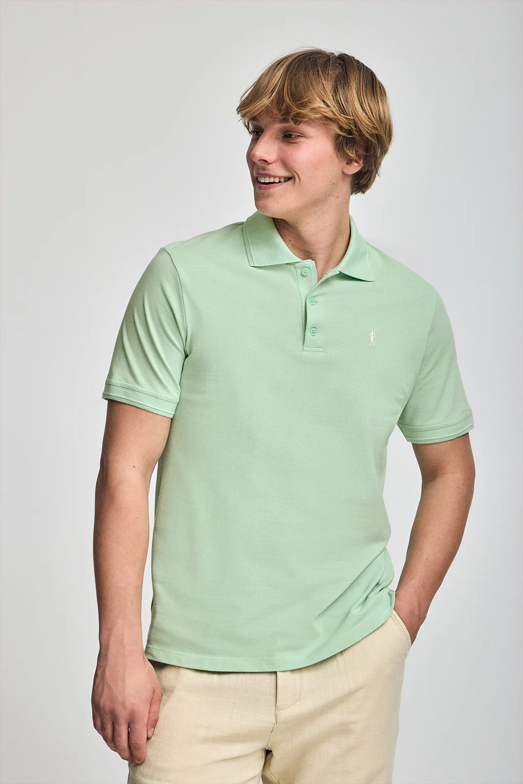 Mint short-sleeve polo shirt with three buttons and Rigby Go embroidered logo
