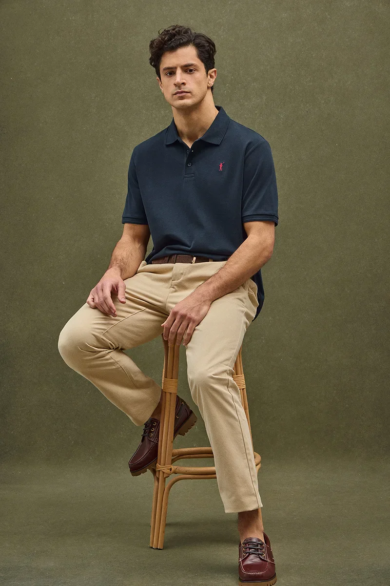 Navy-blue short-sleeve polo shirt with Rigby Go embroidered logo