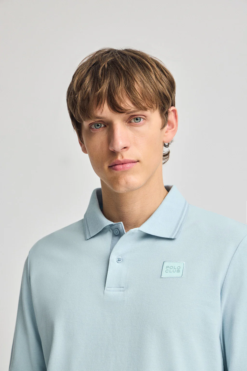 Light-blue long-sleeve polo shirt with two buttons and branded patch - Image 3