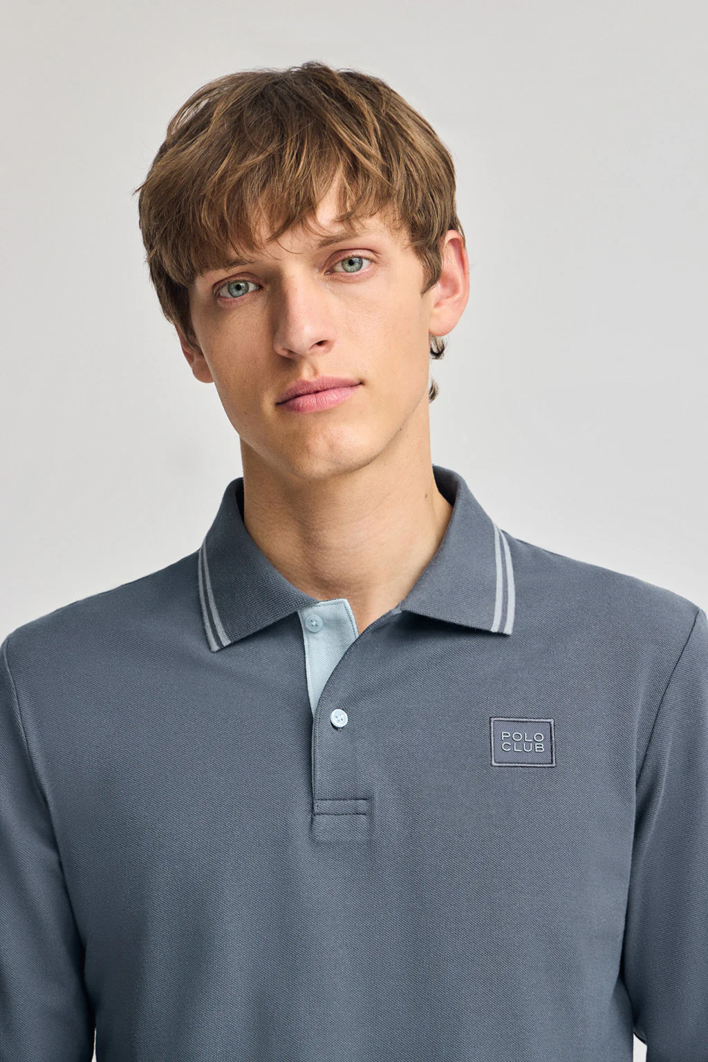 Denim-blue long-sleeve polo shirt with two buttons and branded patch - Image 3