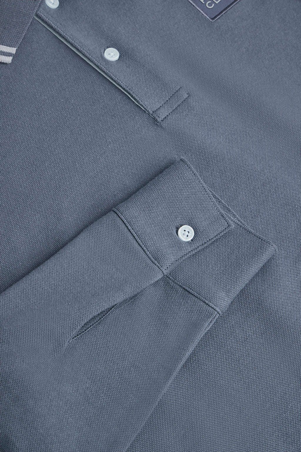 Denim-blue long-sleeve polo shirt with two buttons and branded patch - Image 7