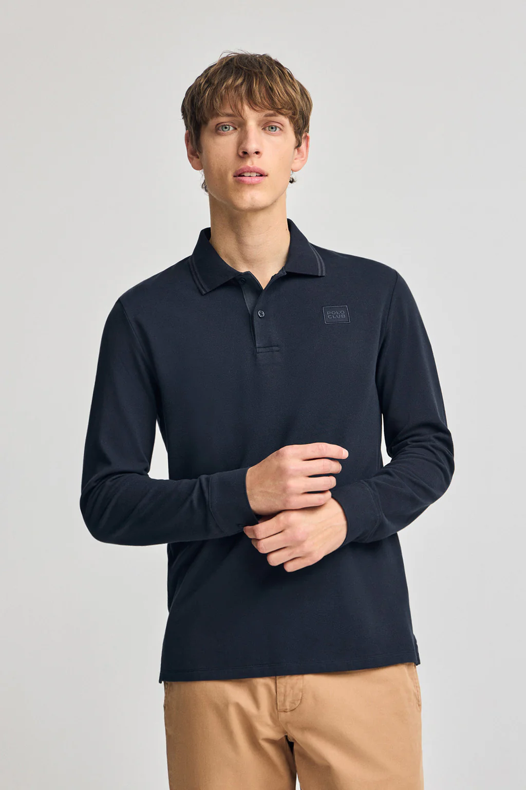 Navy-blue long-sleeve polo shirt with two buttons and branded patch