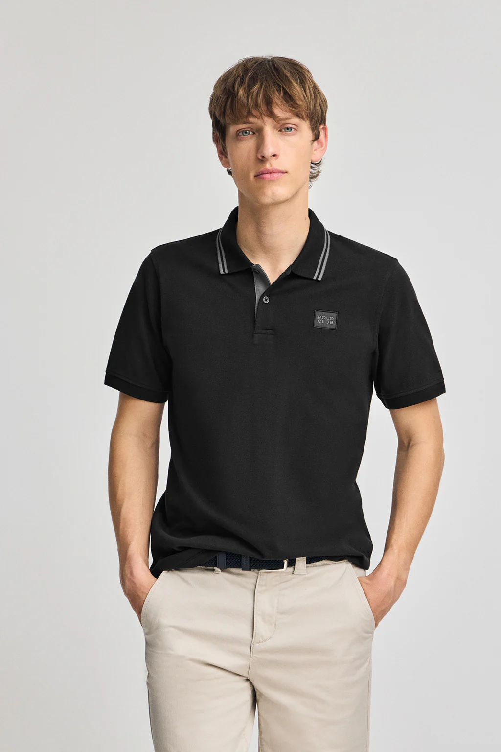 Black short-sleeve polo shirt with two buttons and chest detail