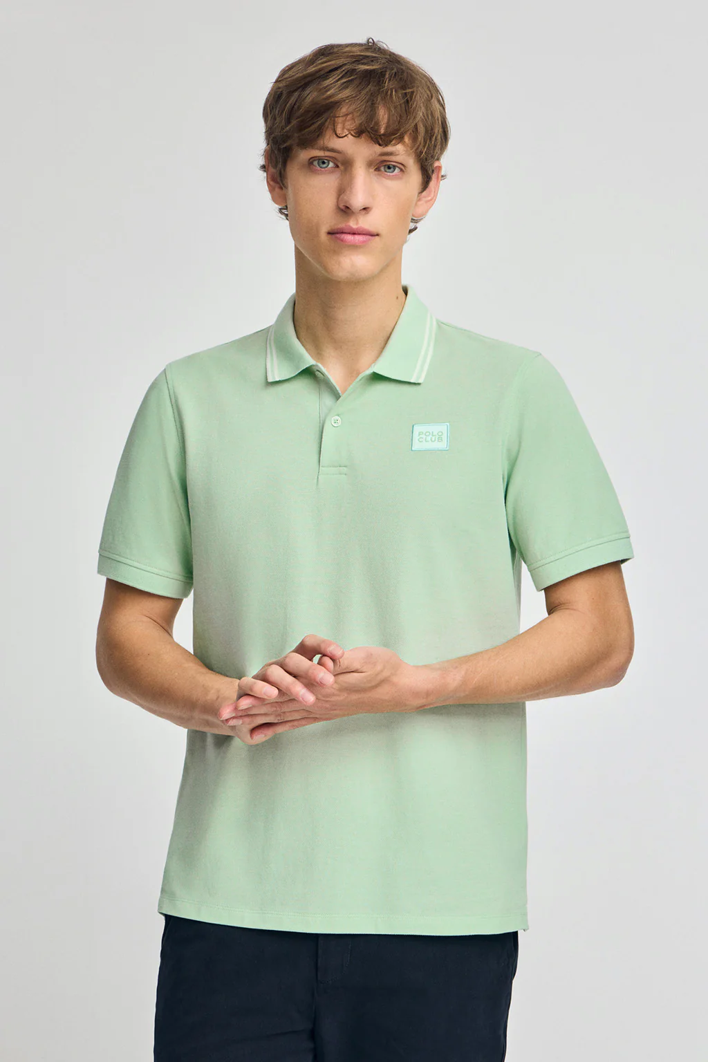 Mint short-sleeve polo shirt with two buttons and chest detail