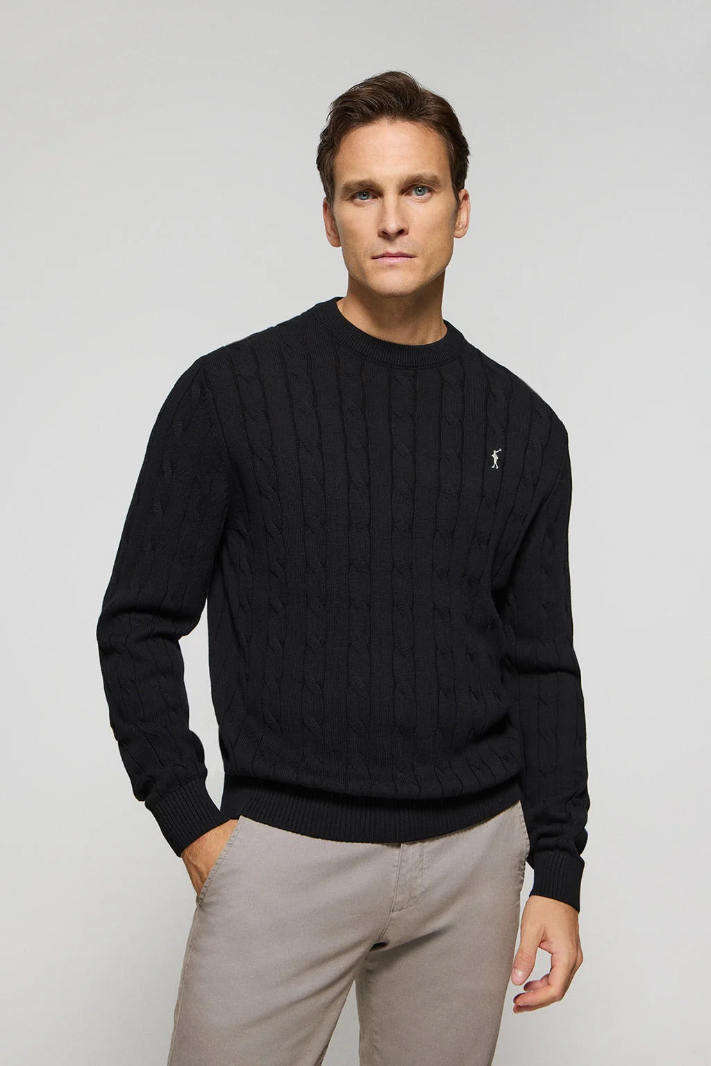 Black cable-knit jumper with Rigby Go logo