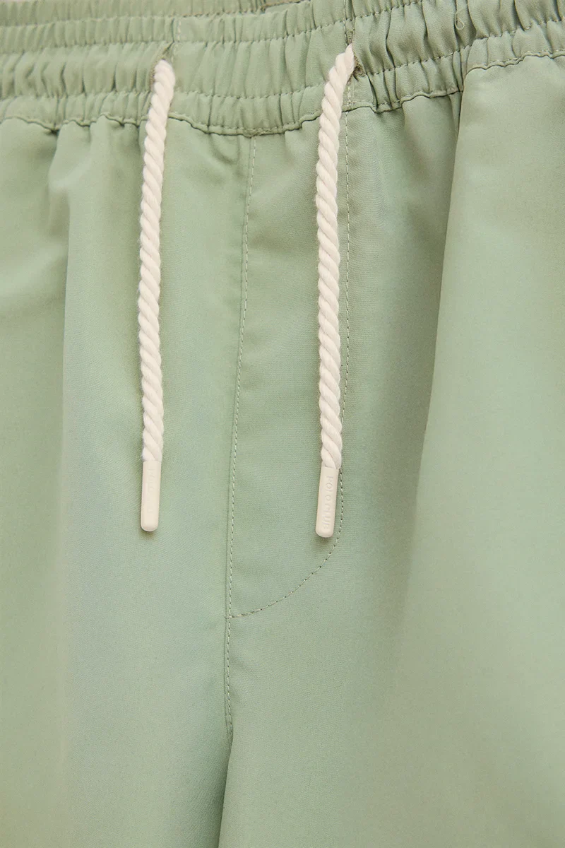 Pale-green short swim shorts with Rigby Go logo - Image 3