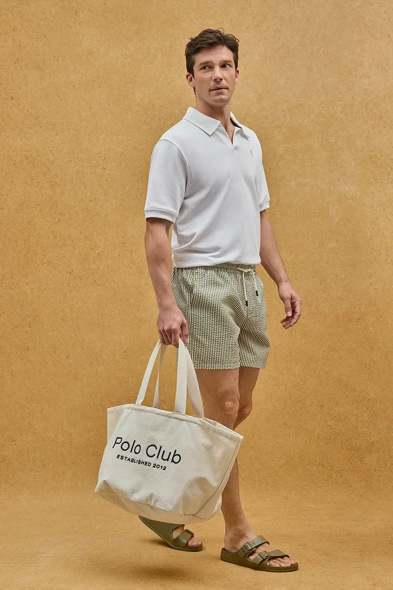 Short swim shorts in moss green and nude with crinkled texture and Rigby Go logo