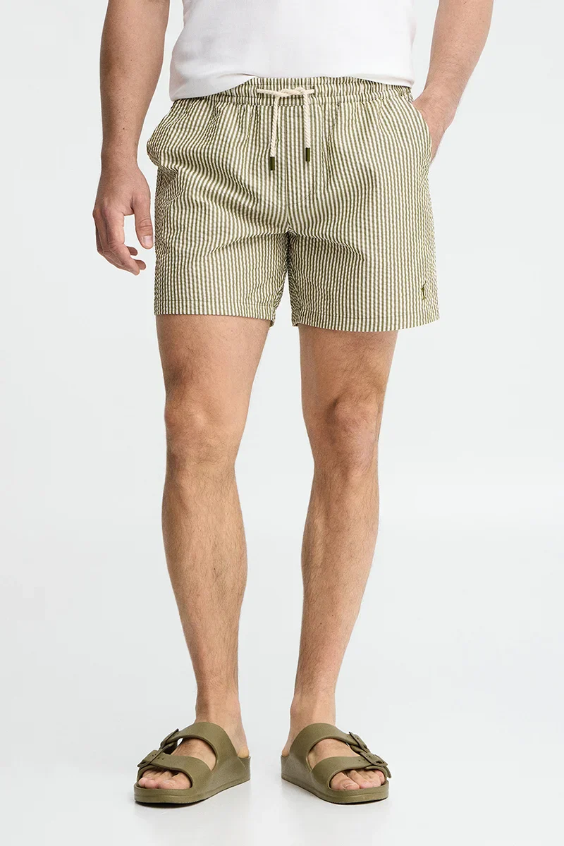 Short swim shorts in moss green and nude with crinkled texture and Rigby Go logo - Image 2