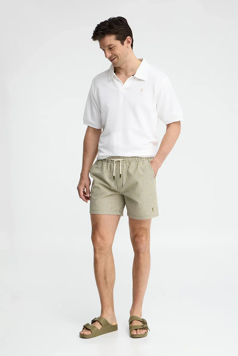Short swim shorts in moss green and nude with crinkled texture and Rigby Go logo - Image 3