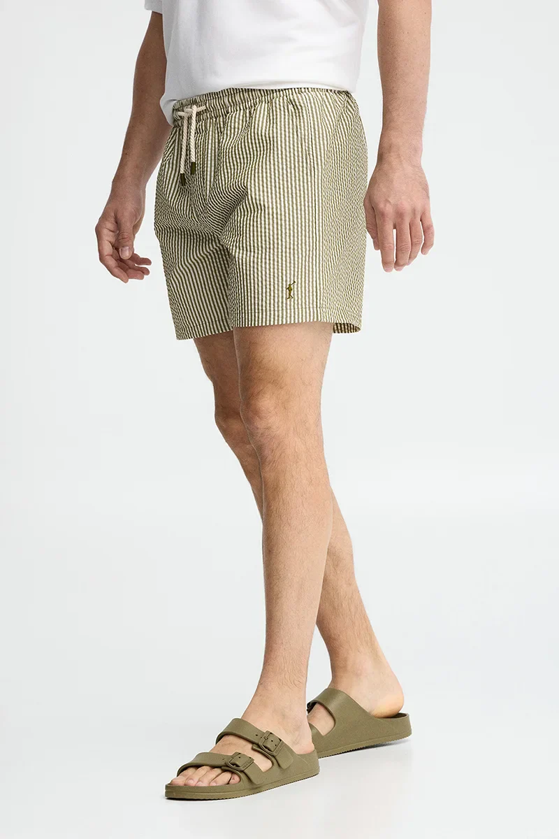 Short swim shorts in moss green and nude with crinkled texture and Rigby Go logo - Image 4