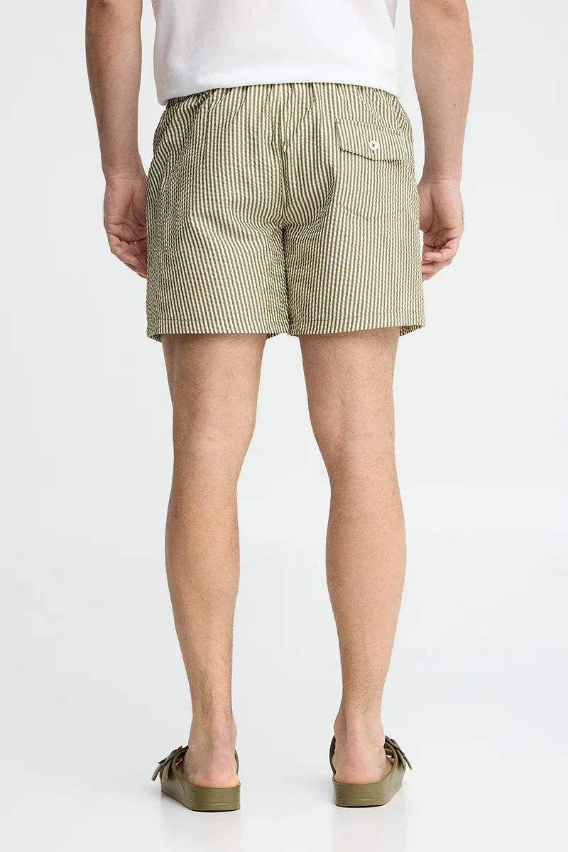 Short swim shorts in moss green and nude with crinkled texture and Rigby Go logo - Image 5