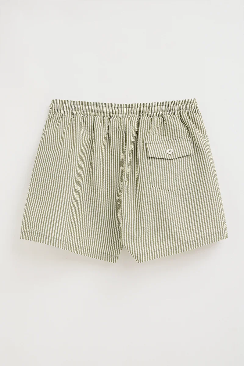 Short swim shorts in moss green and nude with crinkled texture and Rigby Go logo - Image 9