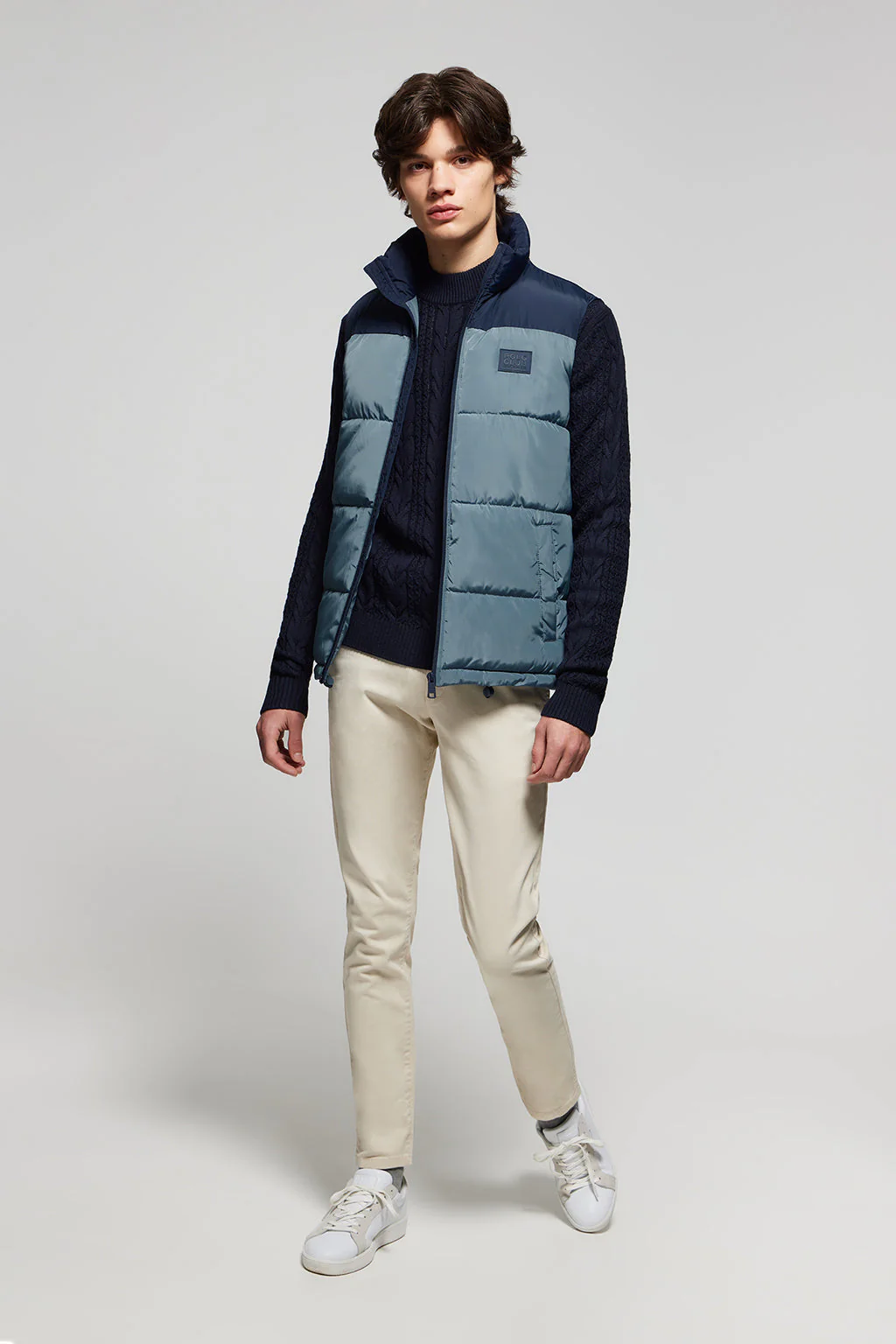 Denim-blue puffer vest with high collar and logo patch - Image 2
